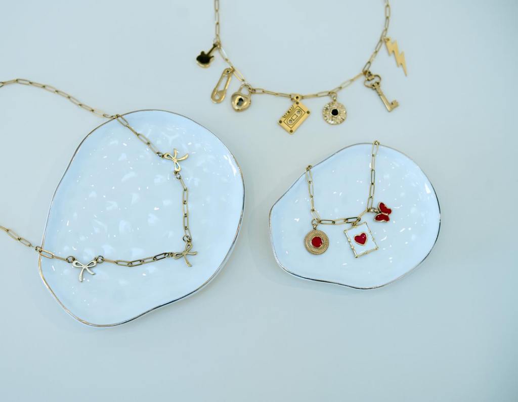 Three gold necklaces with charms
