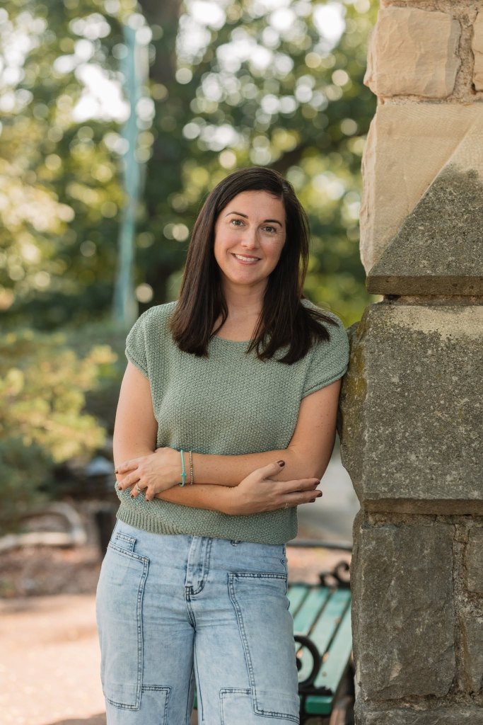 Leah Harper in a green shirt and jeans