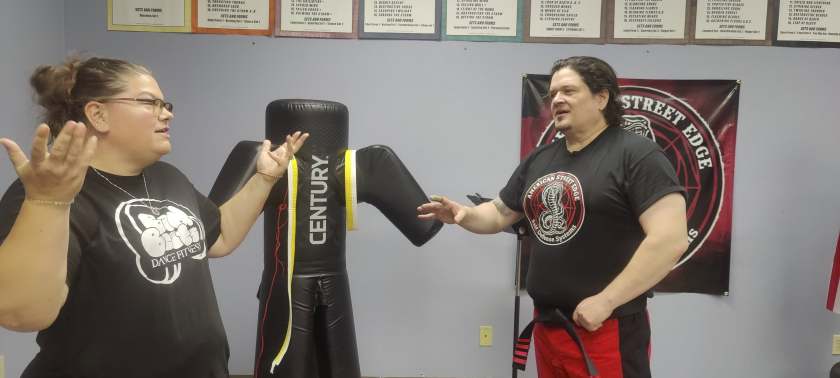 man and woman in self-defense school having heated discussion