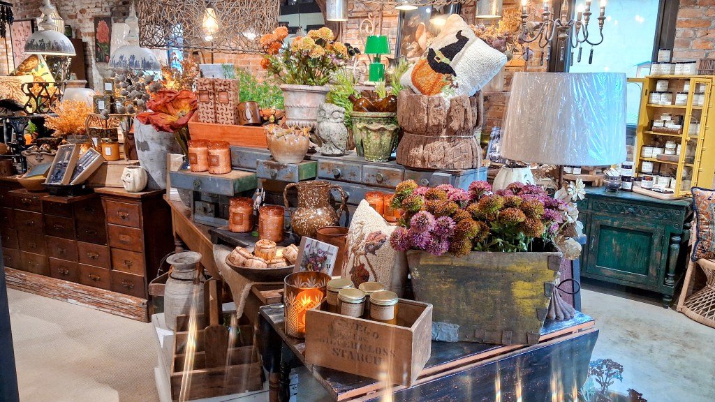a wide shot of the store's display of fall home decor with items like lamps, dried flowers, candles, decorative pillows